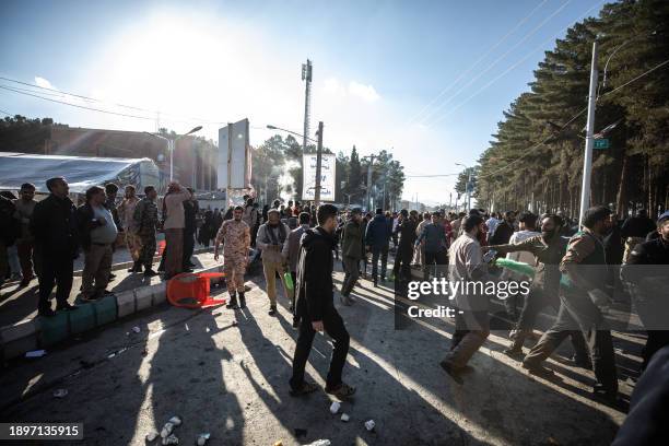 People disperse near the site where two explosions in quick succession struck a crowd marking the anniversary of the 2020 killing of Guards general...