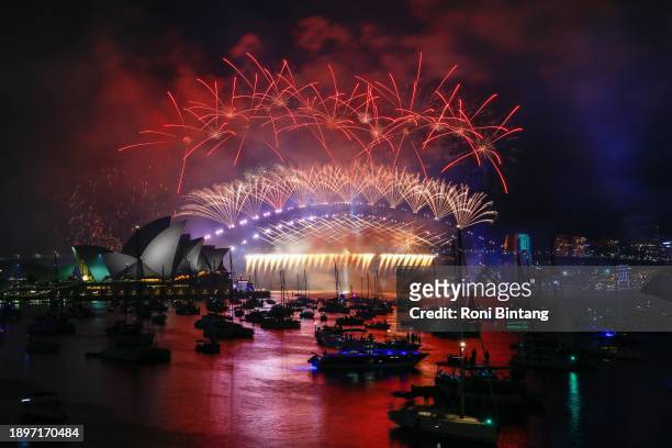 Fireworks light up the sky over the Sydney Harbour Bridge and the Sydney Opera House during New Year's Eve celebrations on January 01, 2024 in...