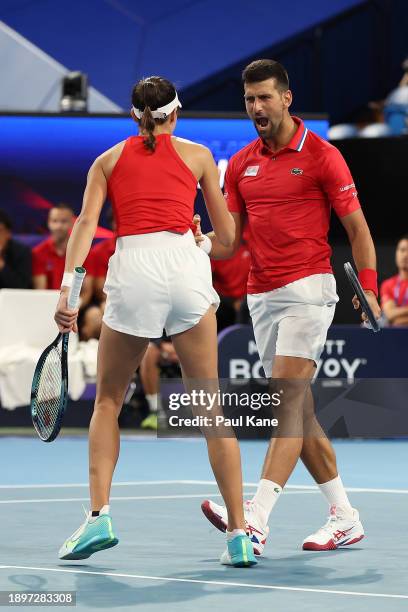 Novak Djokovic and Olga Danilovic of Team Serbia celebrate winning the first set during the mixed doubles match against Qinwen Zheng and Zhang...