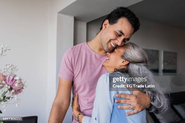 mother and son embraced at home - krama bildbanksfoton och bilder