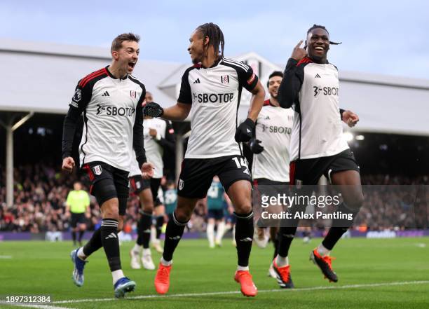 Bobby Reid of Fulham celebrates with teammates Timothy Castagne and Calvin Bassey after scoring their team's second goal during the Premier League...