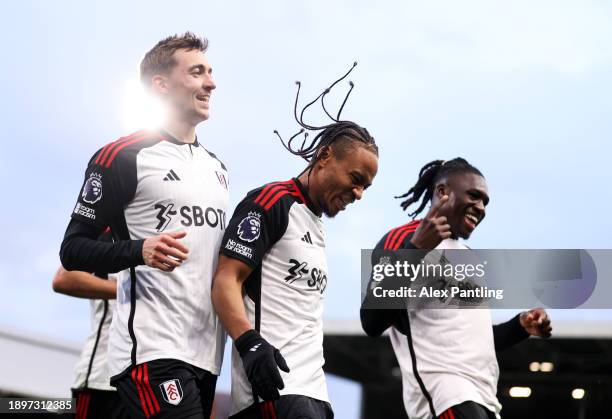 Bobby Reid of Fulham celebrates with teammates Timothy Castagne and Calvin Bassey after scoring their team's second goal during the Premier League...