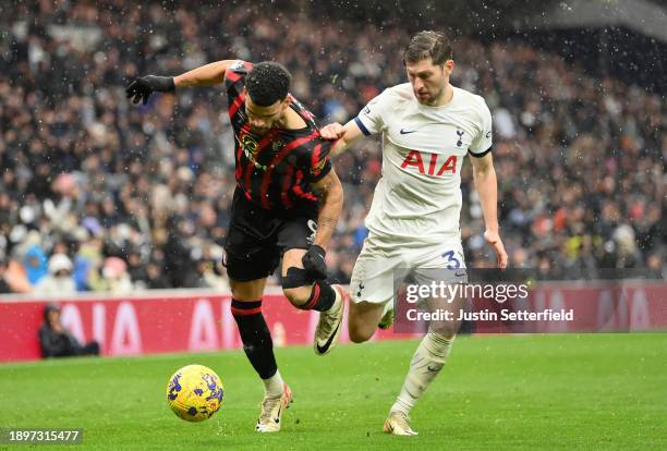 Dominic Solanke of AFC Bournemouth runs with the ball whilst under pressure from Ben Davies of Tottenham Hotspur during the Premier League match...