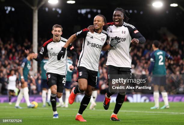 Bobby Reid of Fulham celebrates with teammate Calvin Bassey after scoring their team's second goal during the Premier League match between Fulham FC...