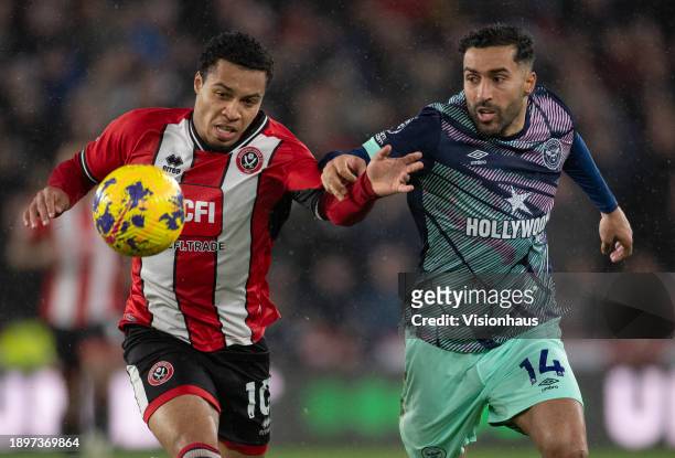 Cameron Archer of Sheffield United and Saman Ghoddos of Brentford in action during the Premier League match between Sheffield United and Brentford FC...