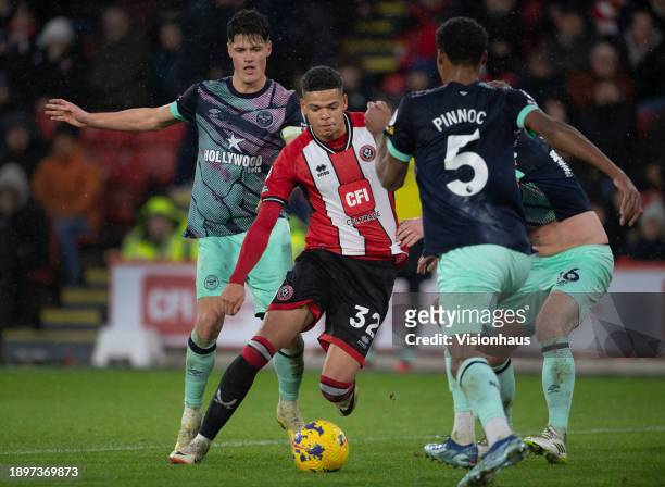 William Osula of Sheffield United in action with Ethan Pinnock, Christian Norgaard and Ben Mee of Brentford during the Premier League match between...