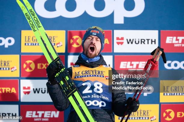 Perttu Hyvarinen of Finland reacts on the podium after winning the 10 Km Classic on December 31, 2023 in Toblach Hochpustertal, Italy.