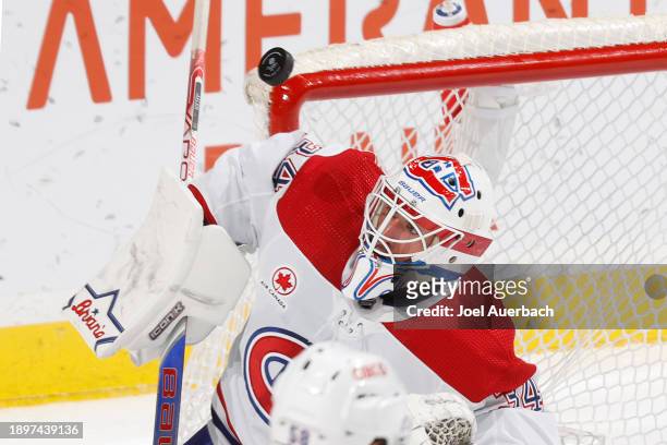 Goaltender Jake Allen of the Montreal Canadiens looks p at the puck after the shot by the Florida Panthers travels over the net at the Amerant Bank...