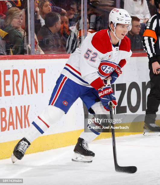 Justin Barron of the Montreal Canadiens clears the puck from behind the net against the Florida Panthers at the Amerant Bank Arena on December 30,...