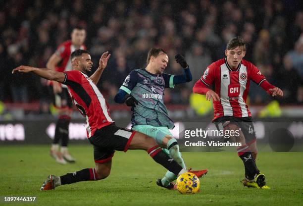 Mikkel Damsgaard of Brentford in action with Ryan One and Sydie Peck of Sheffield United during the Premier League match between Sheffield United and...