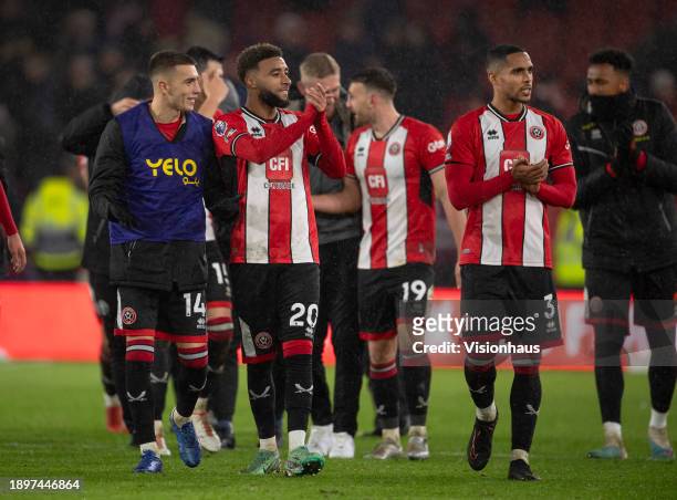 Sheffield United players Luke Thomas, Jayden Bogle and Max Lowe acknowledge the fans after the Premier League match between Sheffield United and...