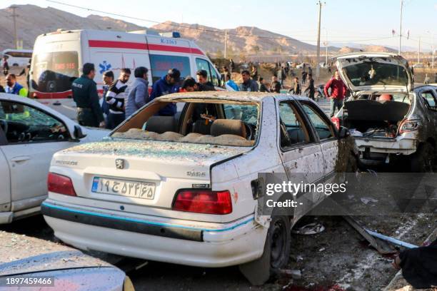 This photograph taken on January 3, 2024 shows destroyed cars and emergency services near the site where two explosions in quick succession struck a...