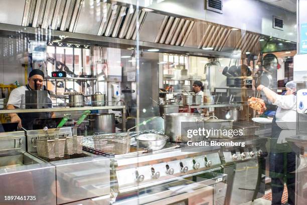 Workers inside a kitchen at the Mercado Central in Santiago, Chile, on Tuesday, Jan. 2, 2024. Chile's economic activity expanded more than expected...