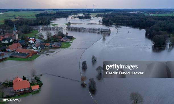 In this aerial view trees stands amidst floodwaters from the nearby Hunte river on January 3, 2023 near Wildeshausen, Germany. Communities along...