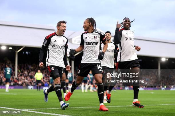 Bobby Reid of Fulham celebrates with Calvin Bassey and Timothy Castagne after scoring his sides second goal during the Premier League match between...