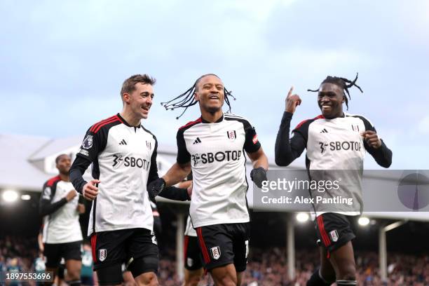 Bobby Reid of Fulham celebrates with Calvin Bassey and Timothy Castagne after scoring his sides second goal during the Premier League match between...