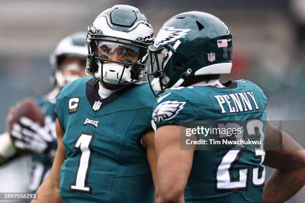 Jalen Hurts and Rashaad Penny of the Philadelphia Eagles warm up before the game against the Arizona Cardinals at Lincoln Financial Field on December...