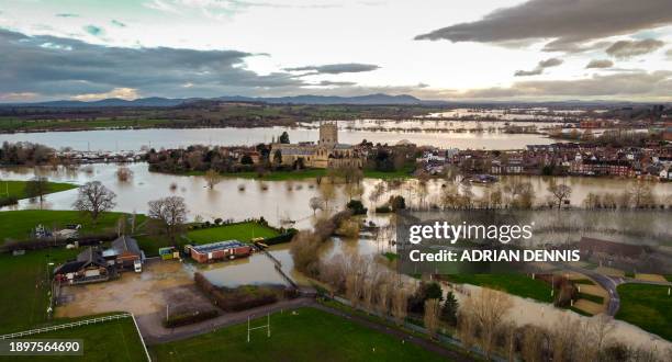 An aerial view shows Tewkesbury Abbey surrounded by floodwater after the Rivers Swilgate and Avon burst their banks in Tewkesbury, western England on...