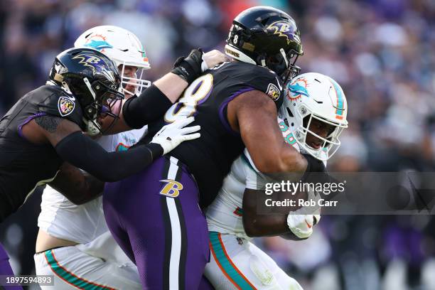 De'Von Achane of the Miami Dolphins carries the ball against the Baltimore Ravens during the first quarter of the game at M&T Bank Stadium on...