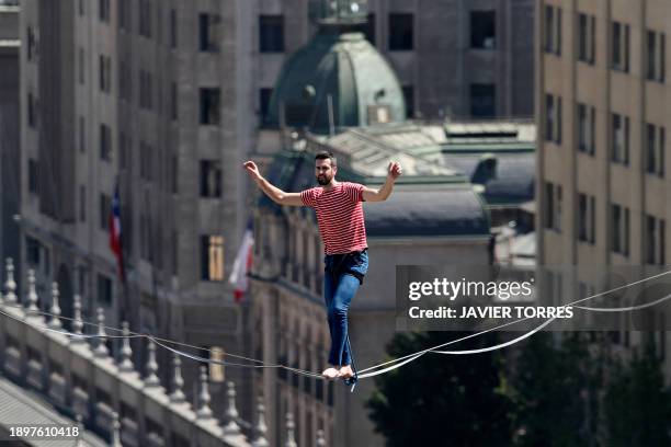 French tightrope walker Nathan Paulin crosses Alameda Avenue on a 270-metre long taut rope, 50 metres above ground, on the opening day of the Teatro...