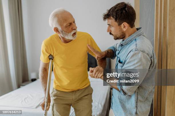 son helping his father - hip replacement stock pictures, royalty-free photos & images