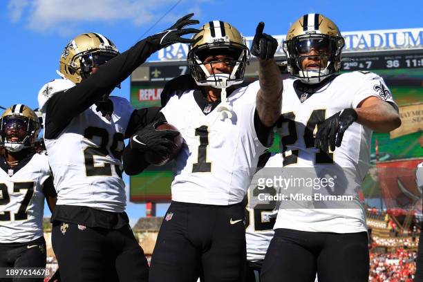 Alontae Taylor of the New Orleans Saints celebrates with teammates after an interception during the second quarter against the Tampa Bay Buccaneers...