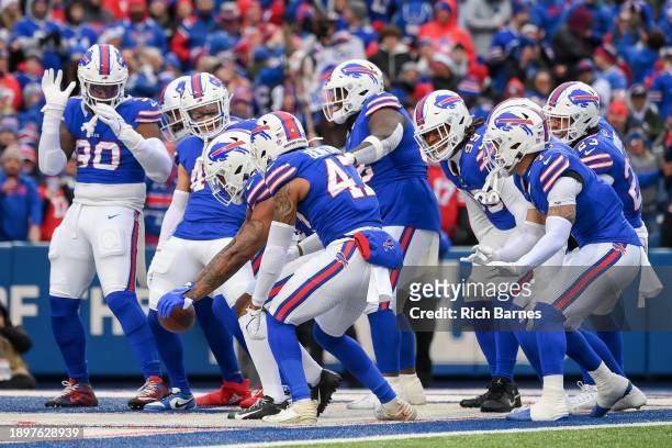 The Buffalo Bills celebrate an interception during the first quarter of a game against the New England Patriots at Highmark Stadium on December 31,...