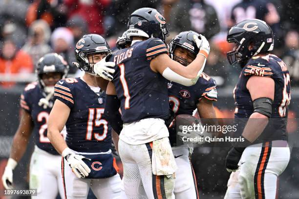 Justin Fields of the Chicago Bears hugs Roschon Johnson of the Chicago Bears after Johnson's rushing touchdown during the second quarter against the...