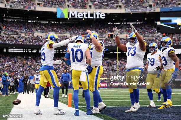 Demarcus Robinson of the Los Angeles Rams, Cooper Kupp of the Los Angeles Rams, and Coleman Shelton of the Los Angeles Rams celebrate after Kupp's...