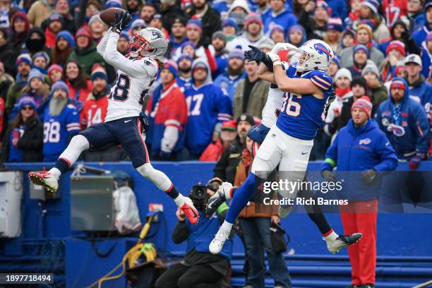 Alex Austin of the New England Patriots intercepts a pass intended for Dalton Kincaid of the Buffalo Bills during the second half at Highmark Stadium...