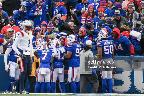 Buffalo Bills players celebrate a interception returned for a touchdown during the first half of a game against the New England Patriots at Highmark...