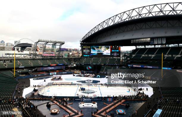 General view is seen of ice crew members working on the ice surface before the 2024 Discover NHL Winter Classic team practice at T-Mobile Park on...