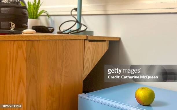 apple on top of small refrigerator in student's dorm room - gateway high school stock pictures, royalty-free photos & images