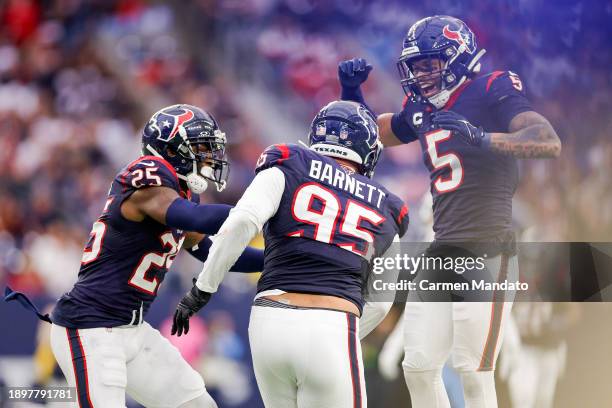 Derek Barnett of the Houston Texans celebrates a fourth quarter sack with Desmond King II of the Houston Texans during a game against the Tennessee...