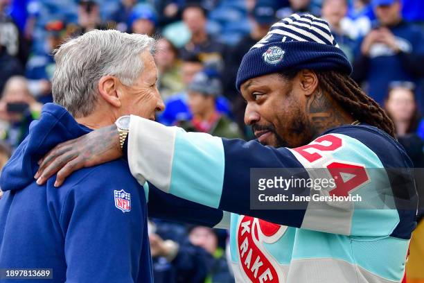 Former Seattle Seattle Seahawks running back Marshawn Lynch meets with head coach Pete Carroll prior to a game against the Pittsburgh Steelers at...