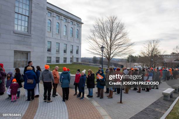 Pro gun supporters and gun safety supports wait in line to talk to their elected officials at the State House after a gun safety rally in Augusta,...