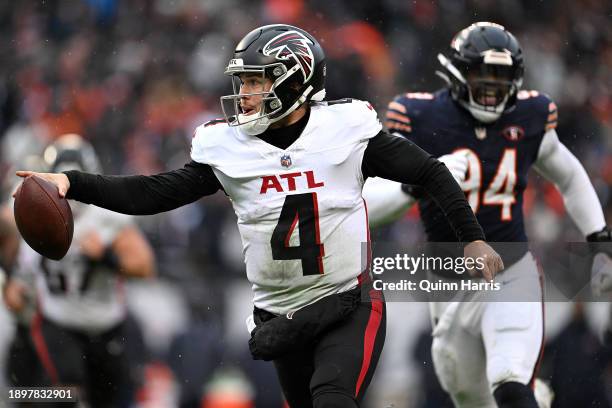 Taylor Heinicke of the Atlanta Falcons runs past Rasheem Green of the Chicago Bears while scoring a touchdown during the fourth quarter at Soldier...