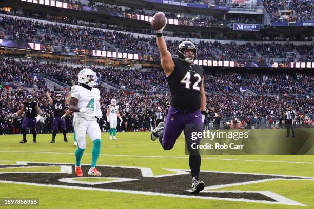 Patrick Ricard of the Baltimore Ravens celebrates after catching a pass for a touchdown against the Miami Dolphins during the fourth quarter of the...