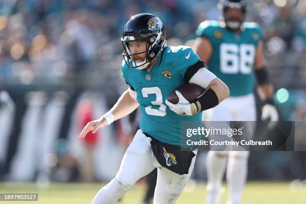 Beathard of the Jacksonville Jaguars runs the ball during the third quarter against the Carolina Panthersat EverBank Stadium on December 31, 2023 in...