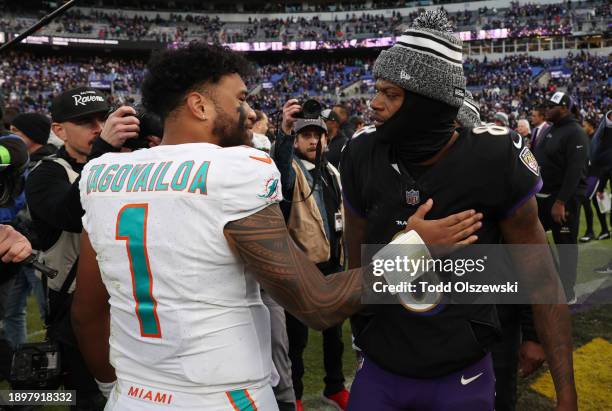 Tua Tagovailoa of the Miami Dolphins and Lamar Jackson of the Baltimore Ravens embrace on the field after their game at M&T Bank Stadium on December...