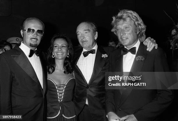 Photo prise le 09 septembre 1980 à Monaco du producteur de musique français Eddie Barclay et son épouse, accompagnés par le chanteur Johnny Hallyday...