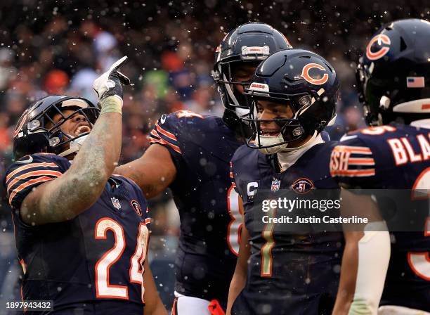 Justin Fields of the Chicago Bears and Khalil Herbert of the Chicago Bears celebrate after Herbert's rushing touchdown during the fourth quarter...