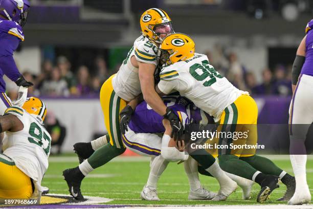 Minnesota Vikings quarterback Jaren Hall is sacked by Green Bay Packers linebacker Lukas Van Ness and Green Bay Packers defensive lineman Colby...