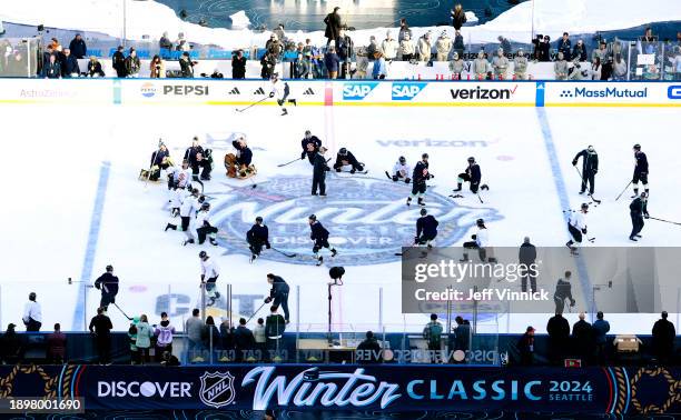 General view is seen of the Seattle Kraken gathere at center ice during the 2024 Discover NHL Winter Classic team practice at T-Mobile Park on...