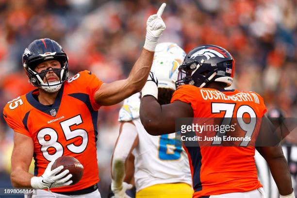 Lucas Krull of the Denver Broncos signals a first down after a catch during the second quarter against the Los Angeles Chargers at Empower Field At...