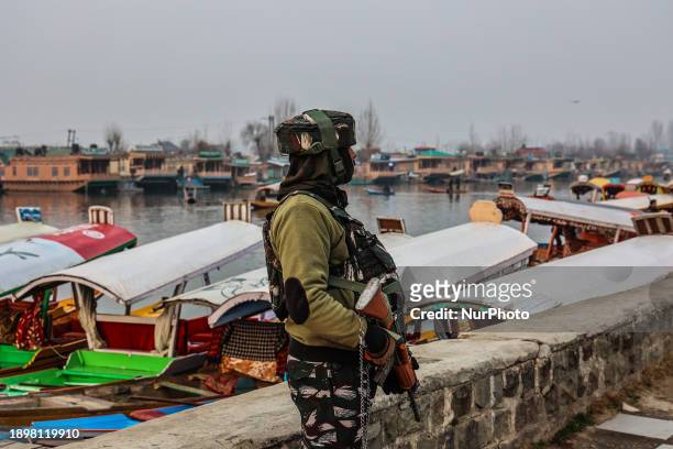 Personnel is standing alert while Shikaras and houseboats are pictured in Dal Lake, Srinagar, Jammu and Kashmir, India, on January 3, 2024.