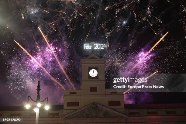 The clock of the Real Casa de Correos congratulates 2024 with fireworks, after the chimes of New Year's Eve 2023, at the Puerta del Sol, on January 1...