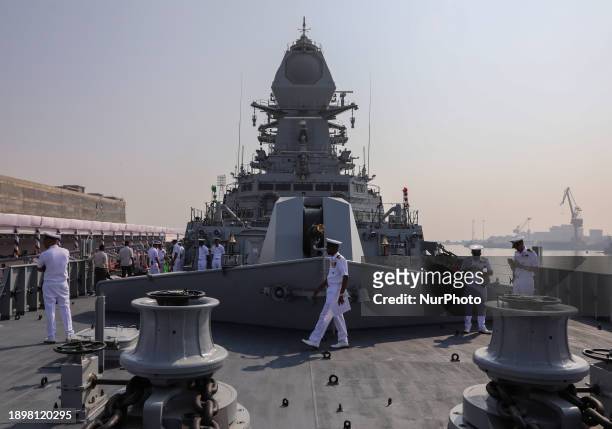 Indian Navy personnel are walking on the deck of INS Imphal, a stealth guided missile destroyer and the third warship of Project-15B, at the Naval...
