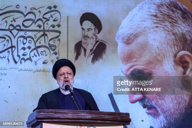 Iranian President Ebrahim Raisi speaks during a commemoration ceremony marking the fourth anniversary of the 2020 killing of Guards general Qasem...