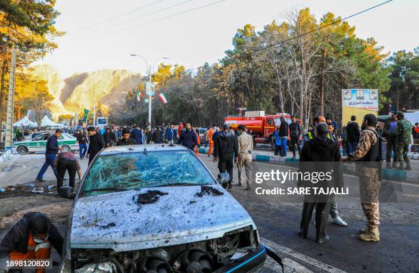 This picture shows people and Iranian emergency personnel at the site where two explosions in quick succession struck a crowd marking the anniversary...